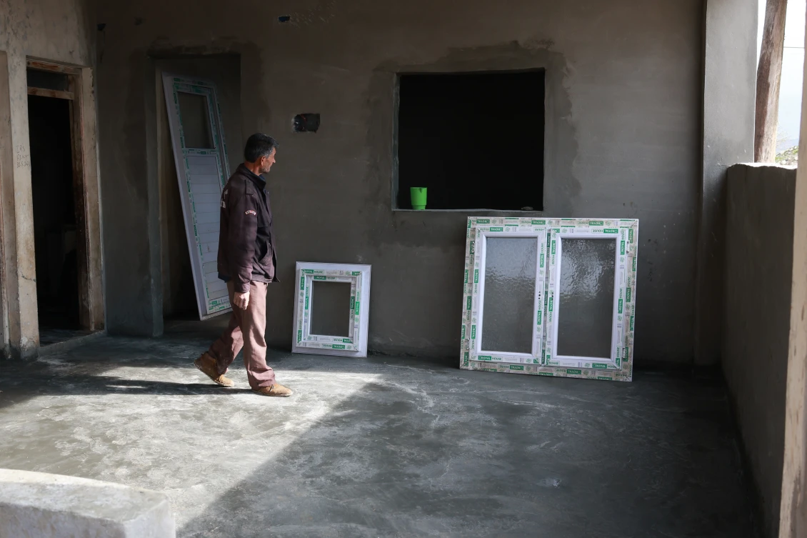 Bashir observes the final touches on his house in northwest Syria. 