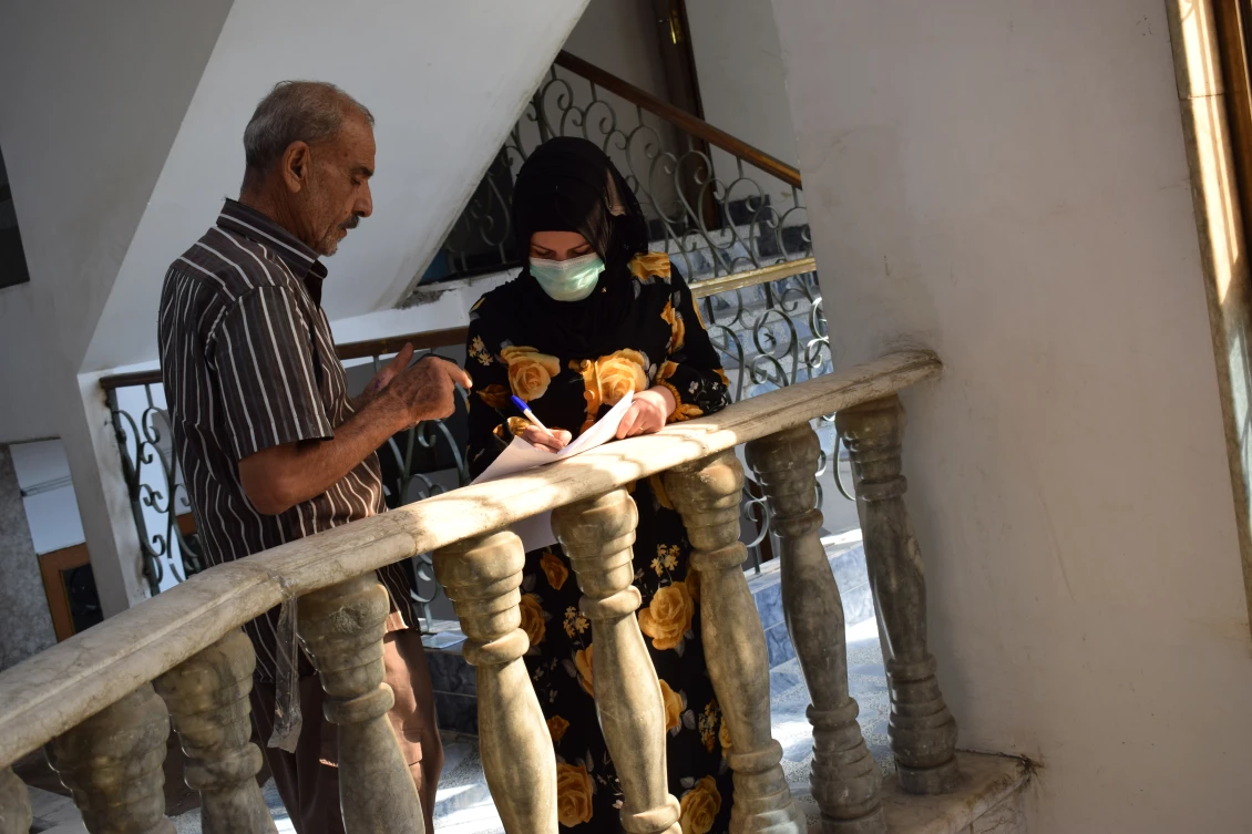 Kawla signing the contract to receive her start-up grant to open up her dream home appliance store