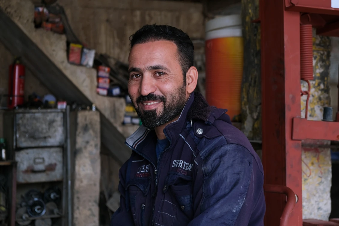 Hamad, 34, posing in his workshop in Beiji, Iraq.