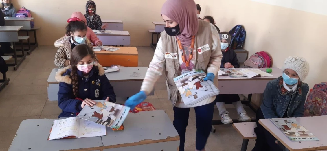 Students receiving the comic book by PIN staff in their schools